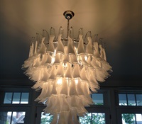 Chandelier with clear & whtie glasses installed over dinning room table. Greenwich, CT.