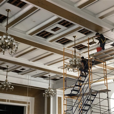 Putting up all the chandeliers after the cleaning and rewiring process.