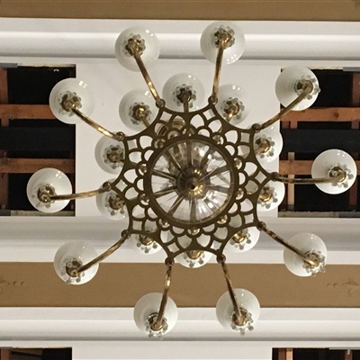Each chandelier has twenty (20) arms and a total of 180 bulbs total for the nine chandeliers of the School's auditorium.